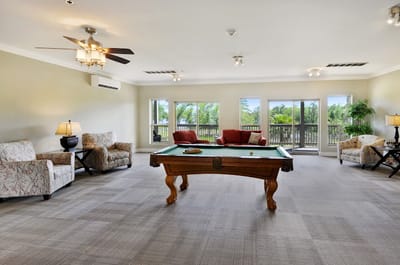 Interior view of a common area with pool table and seating