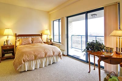 Cozy bedroom with natural light and balcony access