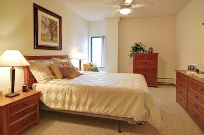 A well-furnished private resident room with warm lighting