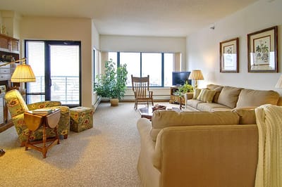 Bright living room with comfortable seating and large windows