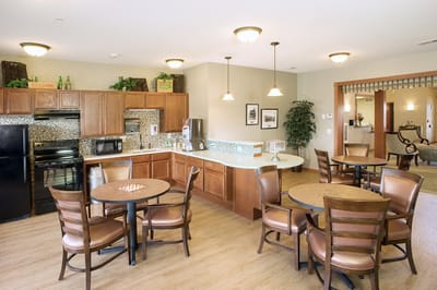 Bright and welcoming dining area with wooden tables and chairs