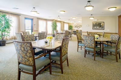 Bright dining room with floral centerpieces and chairs