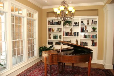 Interior common area with a piano and bookshelves