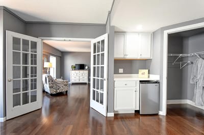 Brightly lit interior room with kitchenette and living area