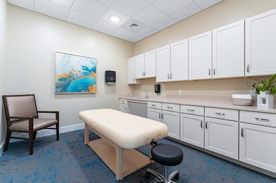 Treatment room with massage table and artwork