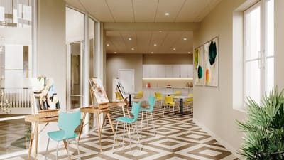 Bright common area with art easels and colorful chairs