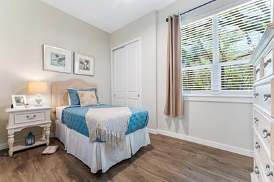Cozy interior of a private resident room with a bed and window