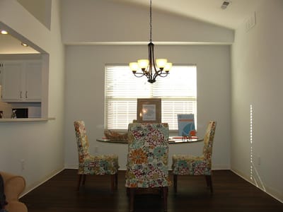 Interior dining area with floral chairs and light fixture