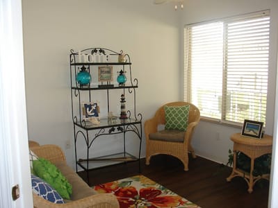 A cozy seated area with decorative shelves and natural light