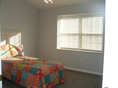 Cozy private room with colorful bedding and natural light