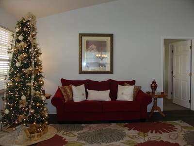 Cozy interior with a red couch and holiday decor