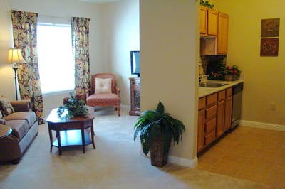 Cozy living area in a resident's suite with a kitchen