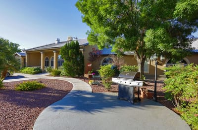 Exterior view of a senior living home with landscaped path