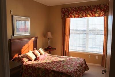 Cozy resident bedroom with floral decor and natural light