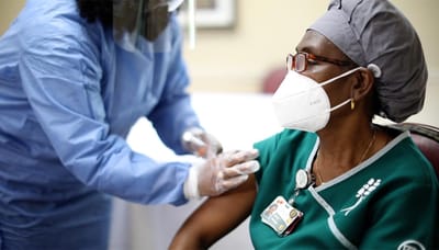 Healthcare worker administering a vaccine to a resident.