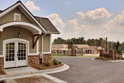 Exterior view of a senior living facility with landscaped pathways.