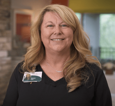 Staff member smiling in a common area
