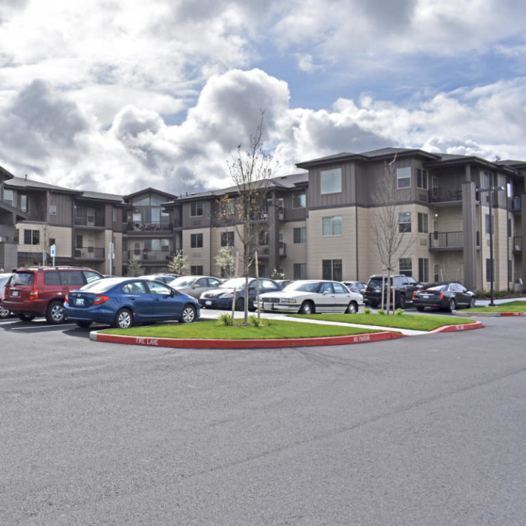 Exterior view of a senior living facility with parking
