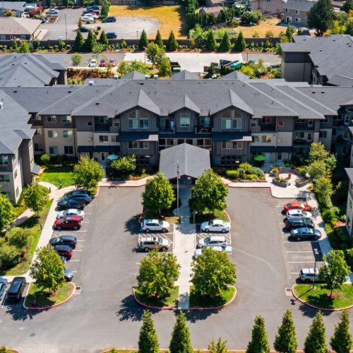 Aerial view of a senior care facility with parking and landscaping