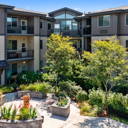 Outdoor area with landscaped gardens and seating