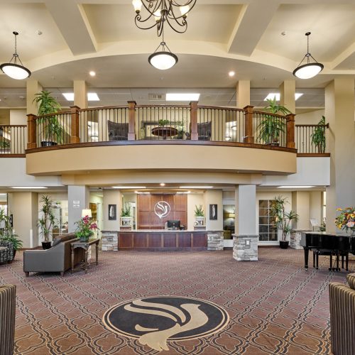 Spacious lobby of a senior living facility with seating areas
