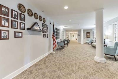 Interior hallway with seating and wall photos