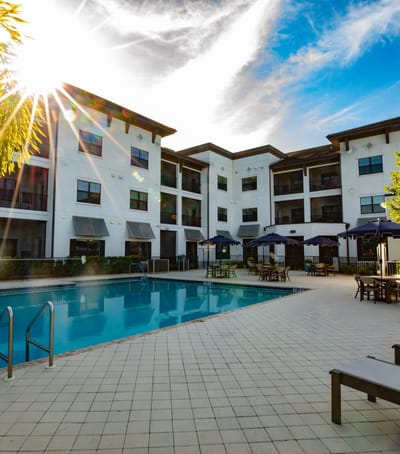 Outdoor pool area with lounge chairs and umbrellas