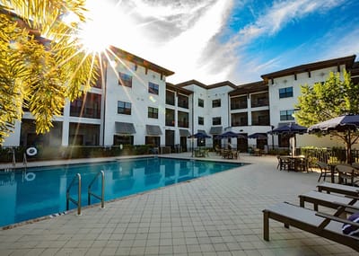 Outdoor pool area with lounge chairs and sun umbrellas