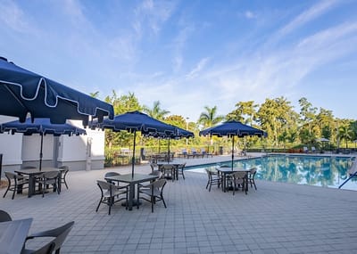 Outdoor pool area with lounge chairs and umbrellas