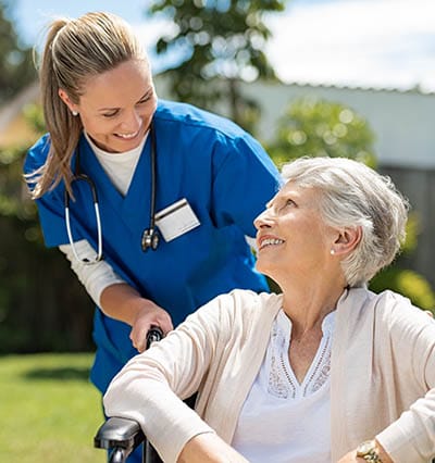 Caregiver interacting with a resident in a garden