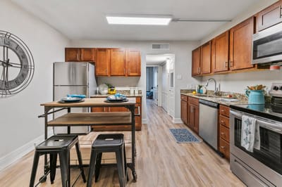 Modern kitchen area with wooden cabinets and appliances