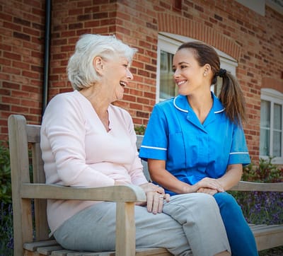 A caregiver and resident having a joyful conversation