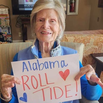 Resident proudly showing a sign for Alabama football