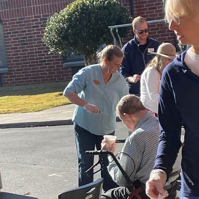Residents and staff engaging in an outdoor activity