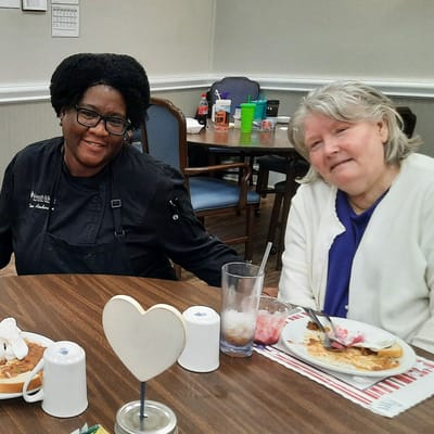 Staff and resident enjoying lunch together