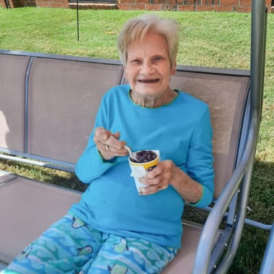 Senior resident enjoying ice cream outdoors