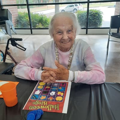Resident enjoying a bingo game in an activity room