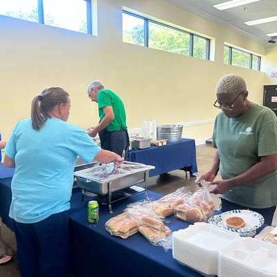 Staff preparing food for an event in a common area