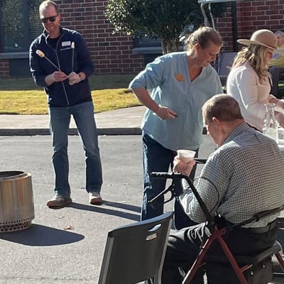 Residents enjoying an outdoor activity with staff support