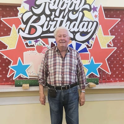 Resident celebrating a birthday in a decorated common area