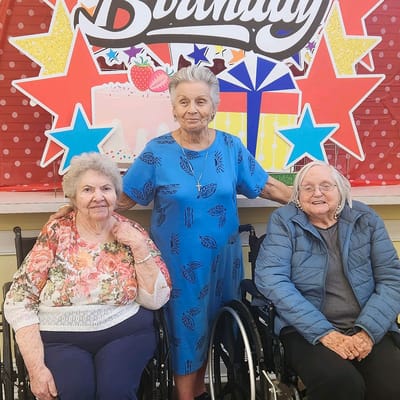 Residents celebrating a birthday in the activity room