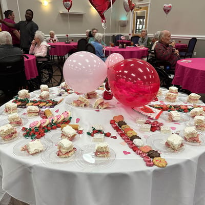 Residents enjoying a dessert event with hearts decorations