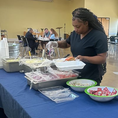 Staff member serving food in the dining area
