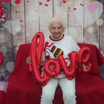A resident holding a 'love' sign during a celebration