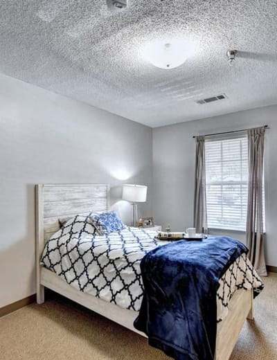 Cozy resident bedroom featuring a neatly made bed