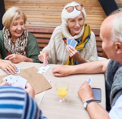 Residents enjoying a card game in a casual setting