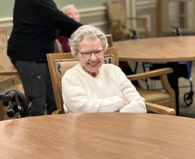 A smiling resident in a common area