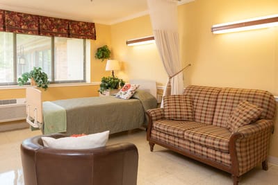 Cozy resident room with a bed and seating area