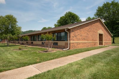 Exterior view of the facility building surrounded by grass