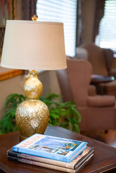 Cozy interior with lamp and books on a table